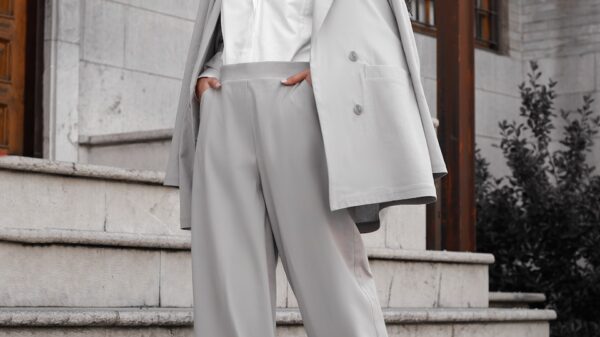 woman in white coat standing on gray concrete stairs