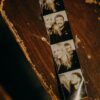 A black and white photobooth strip on a rustic wood surface, evoking nostalgia.