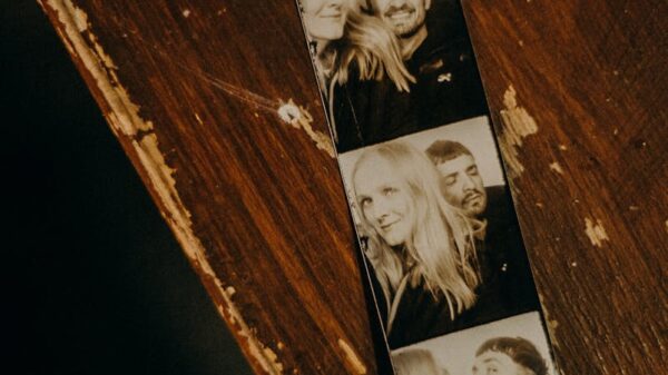 A black and white photobooth strip on a rustic wood surface, evoking nostalgia.