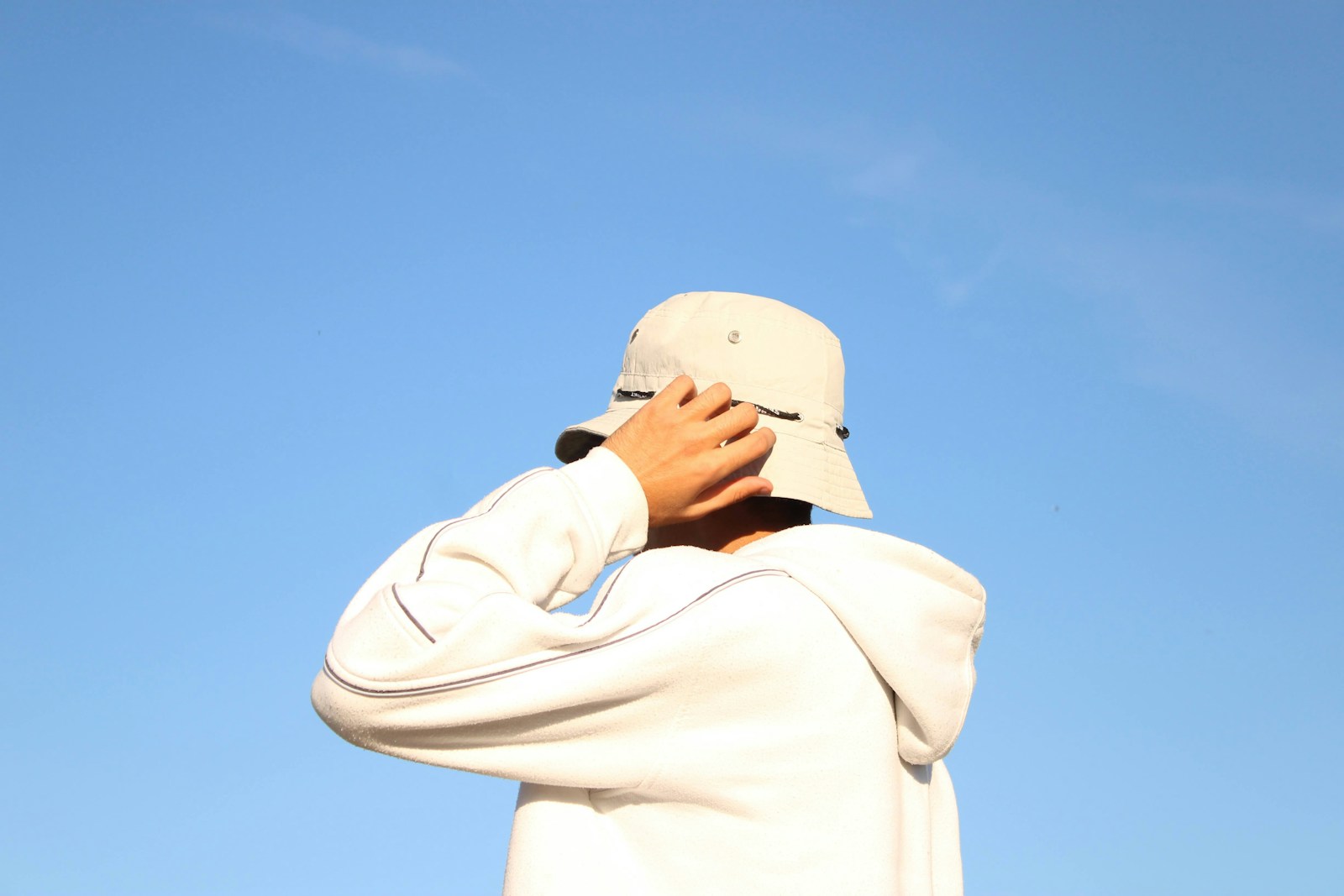 a person wearing a white hat and a white jacket