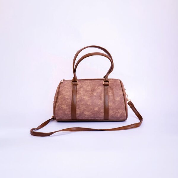Stylish brown leather handbag with handles and strap on a white backdrop.