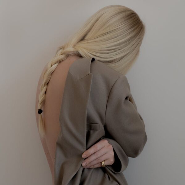 Stylish portrait of a woman in a jacket showing her elegant braided hairstyle.