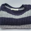 Warm knitted sweater with blue and white stripes, perfect for winter fashion.