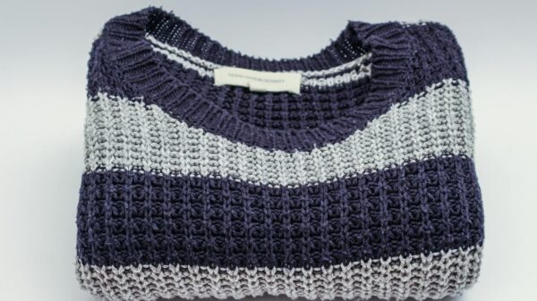Warm knitted sweater with blue and white stripes, perfect for winter fashion.