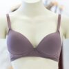 Purple bra displayed on a mannequin in a clothing store, showcasing elegant design.