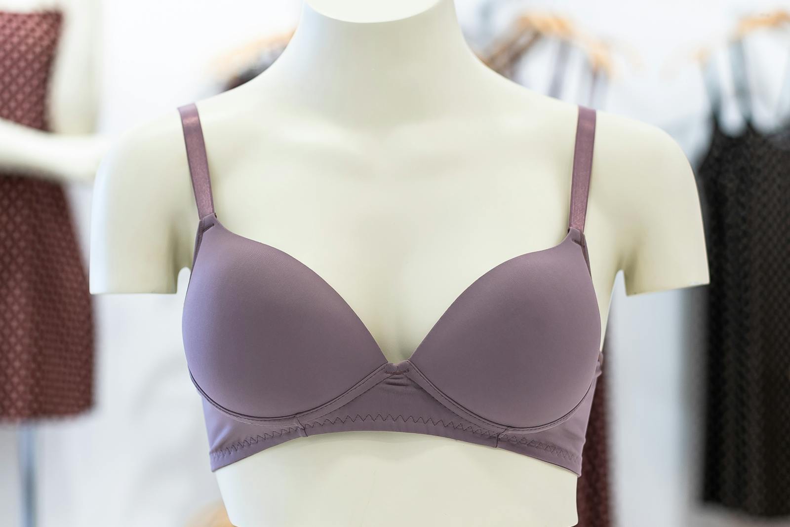 Purple bra displayed on a mannequin in a clothing store, showcasing elegant design.
