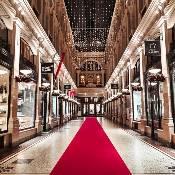 a red carpet is on the floor of a shopping mall