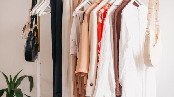 Stylish clothing rack with dresses and accessories in a boutique interior.