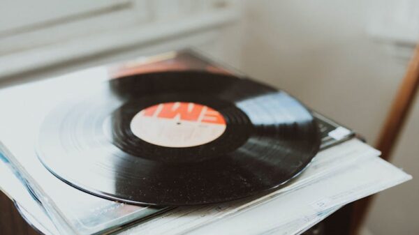 A vinyl record rests on a speaker, creating a nostalgic music atmosphere indoors.