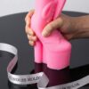 Pink high heel silicone candle mold held by hand on black table in New York. Perfect for creative candle making.