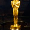 An oscar statue on display in a glass case