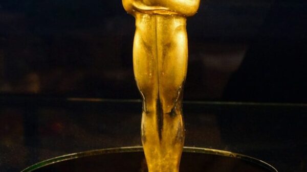 An oscar statue on display in a glass case