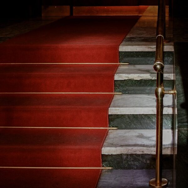 red concrete staircase with stainless steel railings