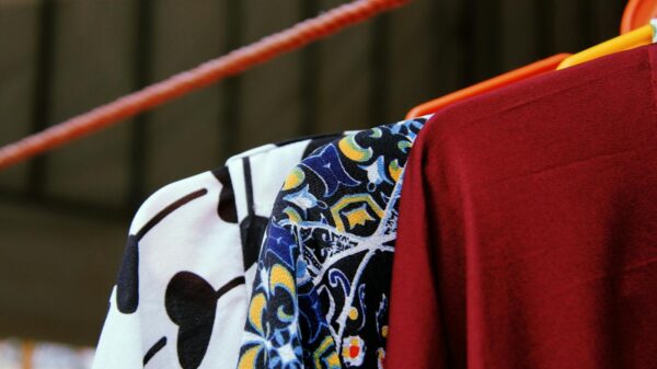 Close-up of vibrant modern fashion garments hanging on a rack.