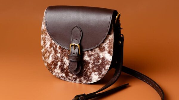 Chic leather sling bag with brown texture, perfect for stylish fashion statements.