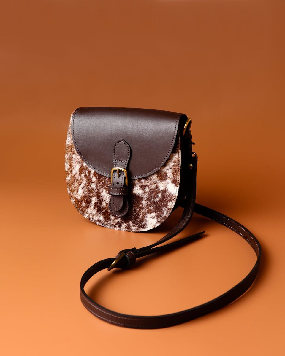 Chic leather sling bag with brown texture, perfect for stylish fashion statements.