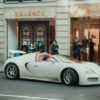 white porsche 911 parked in front of building