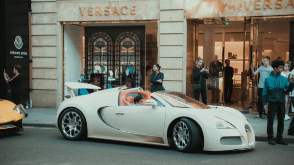 white porsche 911 parked in front of building