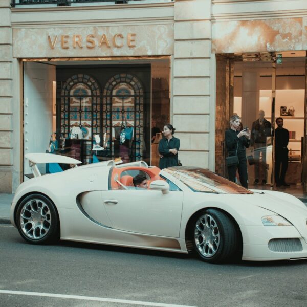 white porsche 911 parked in front of building