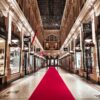a red carpet is on the floor of a shopping mall