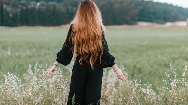 woman standing on green grass field during daytime
