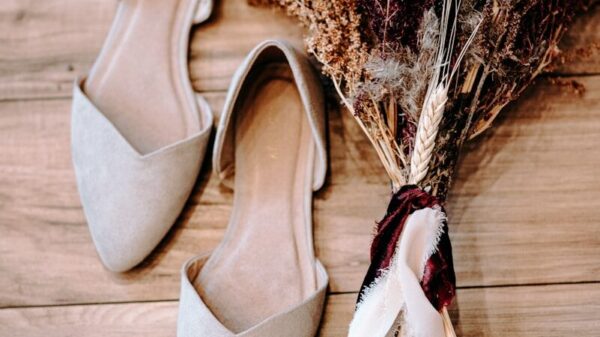 pair of shoes beside flowers