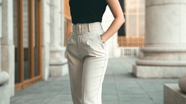 a woman in a black top and white pants