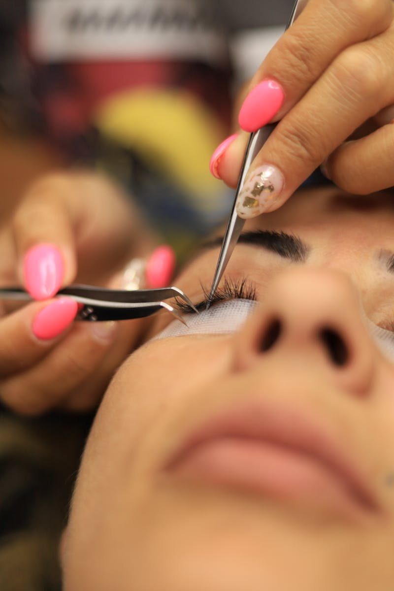 Detailed close-up of an eyelash extension application in a beauty salon.
