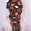 Stunning elegant braid adorned with pink and white flowers, perfect for bridal looks.