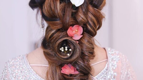 Stunning elegant braid adorned with pink and white flowers, perfect for bridal looks.