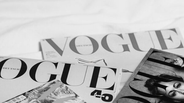 a pile of magazines sitting on top of a bed