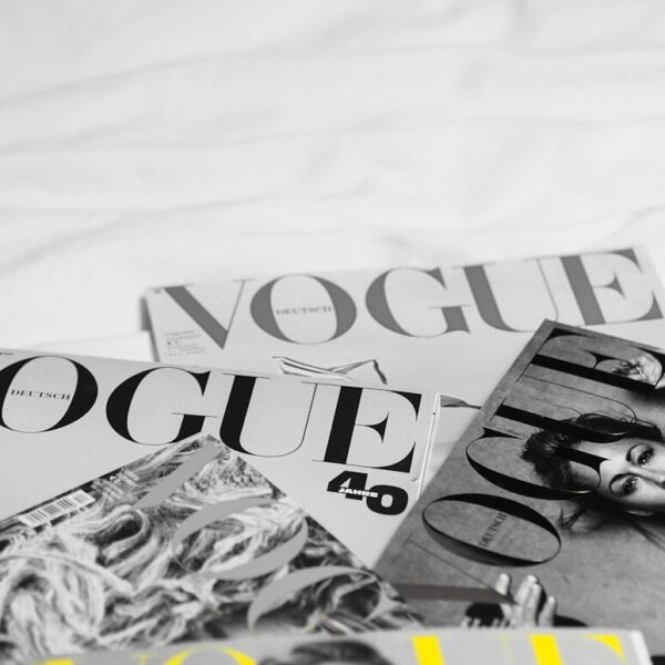 a pile of magazines sitting on top of a bed