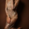 Woman in a sparkling sheer dress with heels