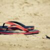Flip-flops resting on a sandy beach