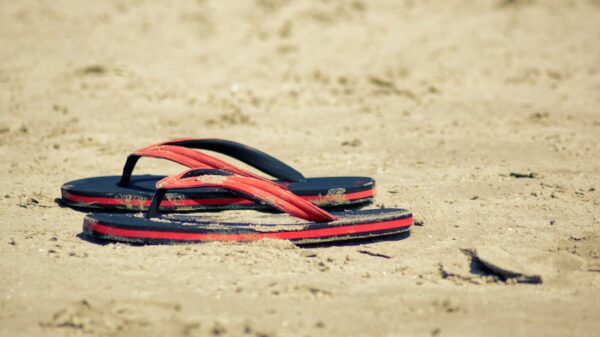 Flip-flops resting on a sandy beach