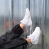 person wearing white nike sneakers