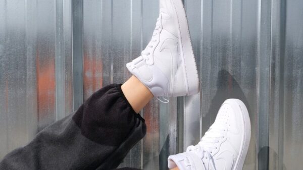 person wearing white nike sneakers