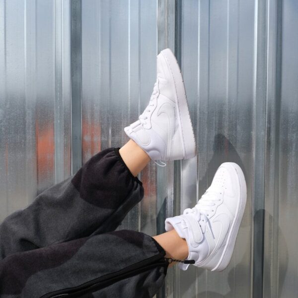 person wearing white nike sneakers