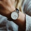 person wearing analog watch