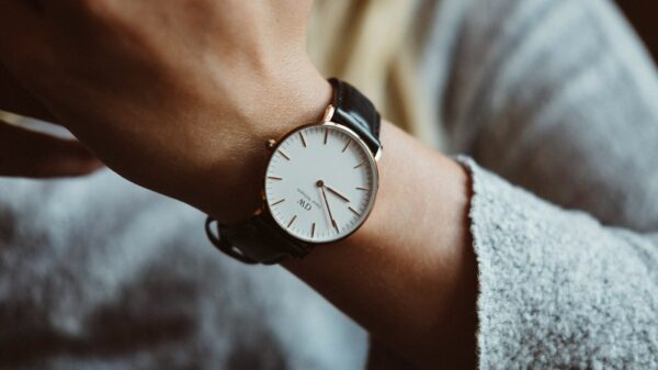 person wearing analog watch