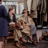 a man sitting in a chair next to a woman
