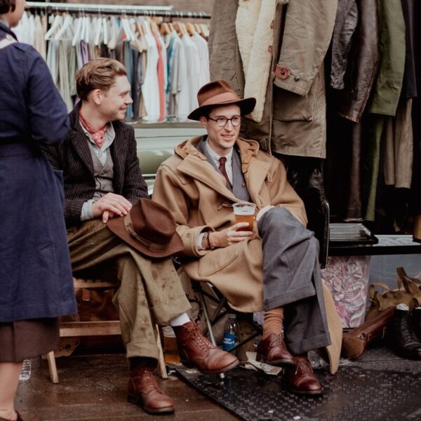 a man sitting in a chair next to a woman