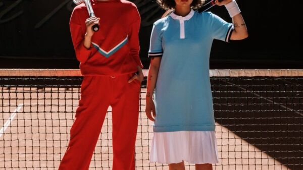 Two athletes in vibrant sport wear posing confidently on a tennis court.