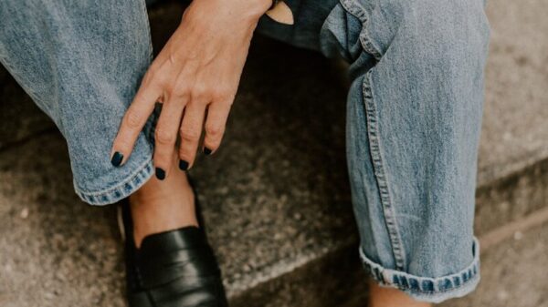 a woman sitting on steps wearing a watch