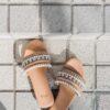 woman in orange and brown leather open toe sandals