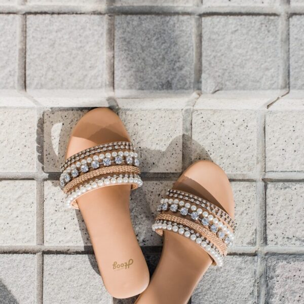 woman in orange and brown leather open toe sandals