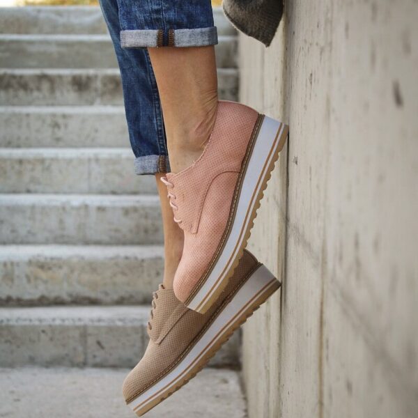 person wearing brown loafers