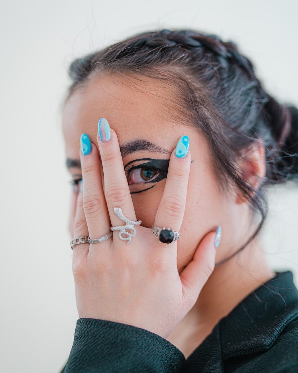 a woman holding her hands to her face