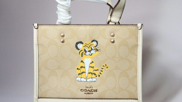 A coach tote bag with a tiger design.