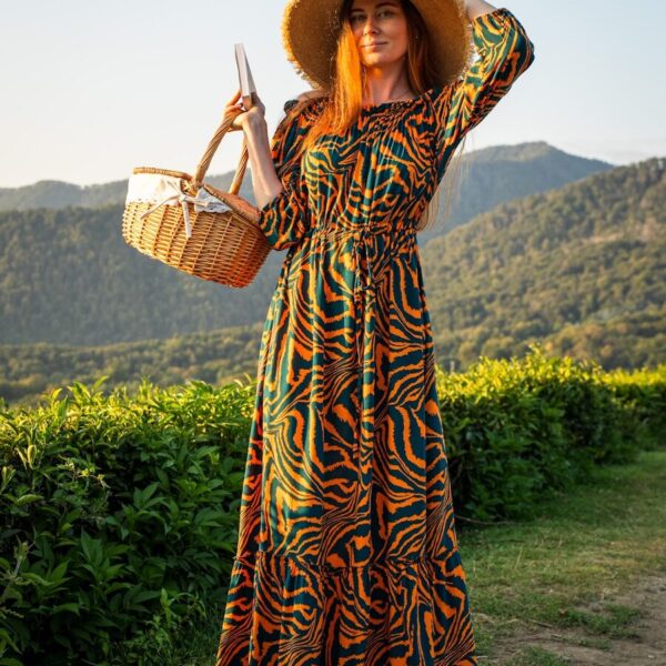 Woman in a patterned dress and hat holding a basket